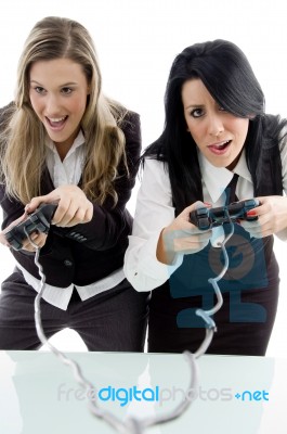 Female Partners Playing Game And Holding Remote Stock Photo