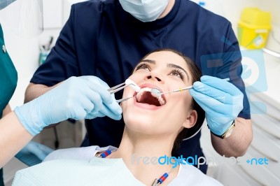 Female Patient Under Dental Treatment Stock Photo