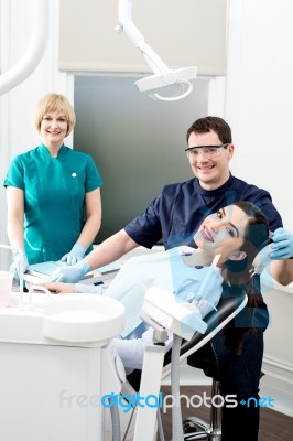 Female Patient With Dentist And Assistant Stock Photo