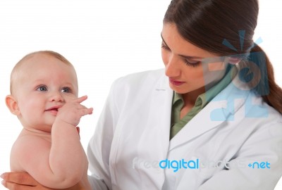 Female Pediatrician Checking Baby Boy Stock Photo