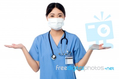 Female Physician Posing With Open Palms Stock Photo