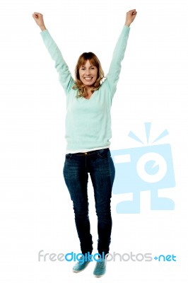 Female Raising Her Arms In Excitement Stock Photo