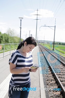 Female Reading Map Book Stock Photo