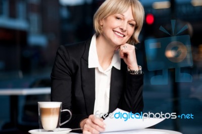 Female Reviewing Business Report Stock Photo