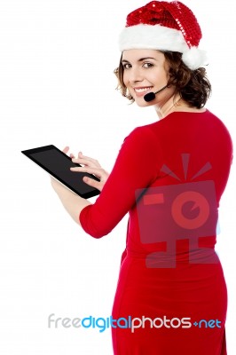 Female Santa Browsing On Her Tablet Pc Stock Photo