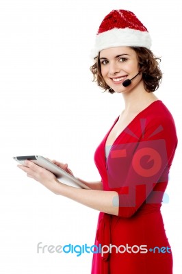 Female Santa Using Her New Tablet Pc Stock Photo