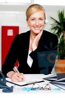 Female Secretary Confirming Appointment Stock Photo