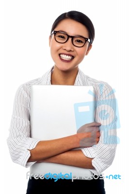 Female Secretary Holding Laptop Tightly Stock Photo