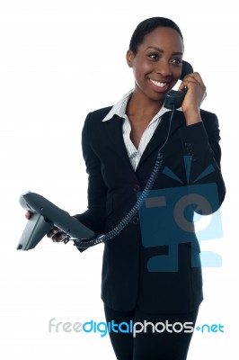 Female Secretary Speaking On Phone Stock Photo