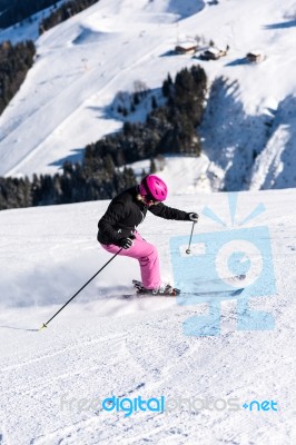 Female Skier In Fresh Powder Snow And Skiing Huts Stock Photo