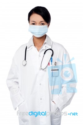 Female Surgeon Posing With Hands In Lab Coat Stock Photo