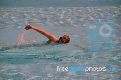 Female Swimming The Crawl Stock Photo