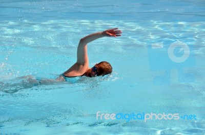 Female Swimming The Crawl Stock Photo