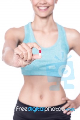 Female Trainer Showing A Pill Stock Photo