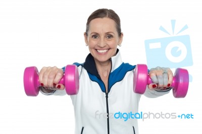 Female Working Out With Pink Dumbbells Stock Photo