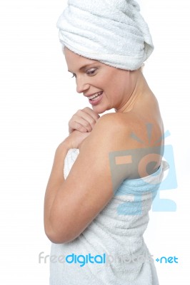 Female Wrapping Herself In Towel After Hot Spa Stock Photo