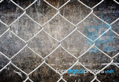 Fence And Grunge Wall Stock Photo