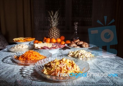 Festively Laid Table With Salads At Night Stock Photo