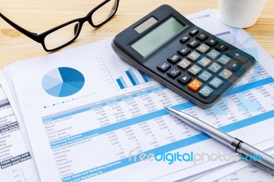 Financial Chart With Calculator And Pen Stock Photo