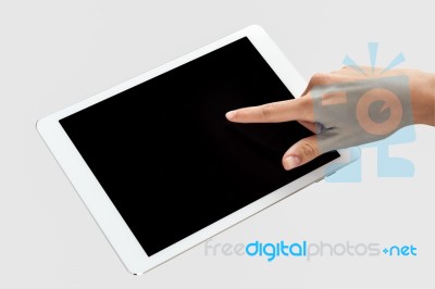 Finger Being Pointed On Tablet Screen Stock Photo