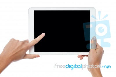 Finger Being Pointed On Tablet Screen Stock Photo