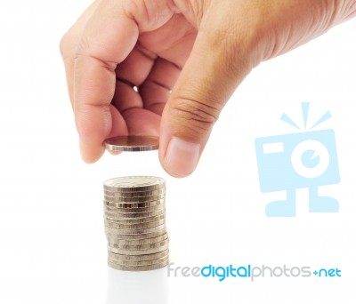 Finger with stacked coins Stock Photo