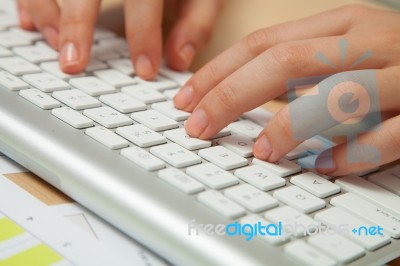 Fingers Typing On Keyboard In Close-up Stock Photo