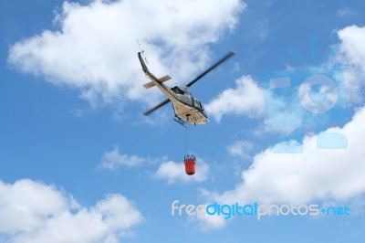 Firefighter Helicopter Flying With Bambi Bucket Stock Photo