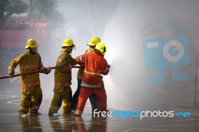 Fireman. Firefighters Fighting Fire During Training Stock Photo