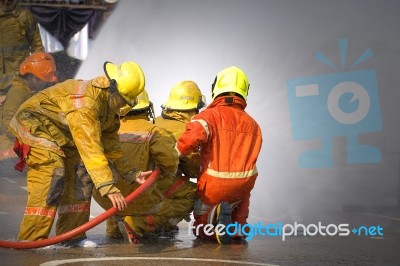 Fireman. Firefighters Fighting Fire During Training Stock Photo