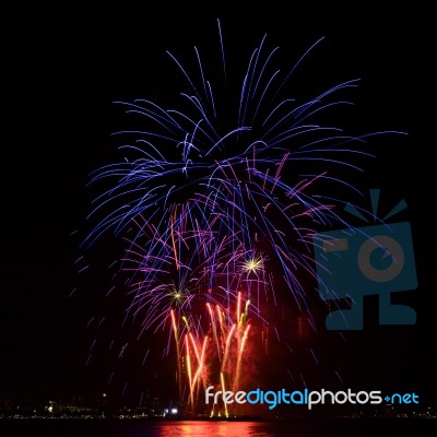 Firework Celebration From The Sea Shore Stock Photo