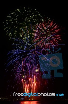 Firework Celebration From The Sea Shore Stock Photo