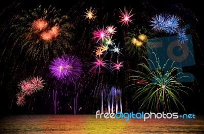 Firework Celebration From The Sea Shore Stock Photo