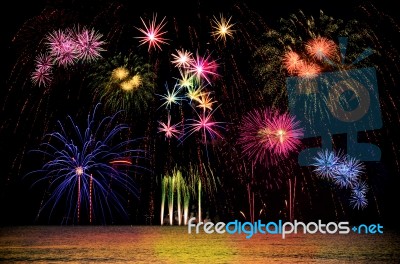 Firework Celebration From The Sea Shore Stock Photo