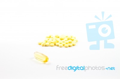 Fish Oil Capsule And Yellow Pills Isolated On White Background Stock Photo