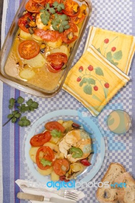 Fish With Potatoes And Tomato Stock Photo