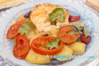 Fish With Potatoes And Tomato Stock Photo