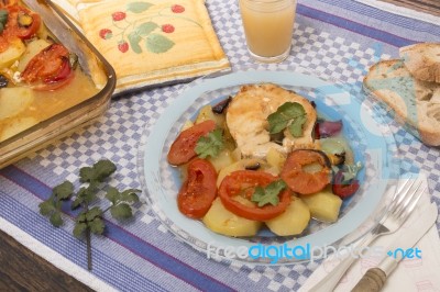 Fish With Potatoes And Tomato Stock Photo