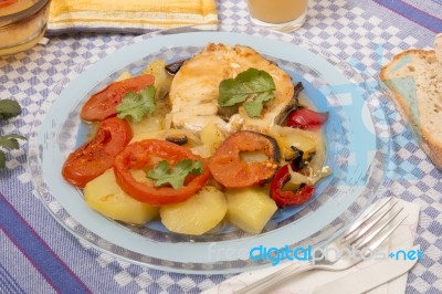 Fish With Potatoes And Tomato Stock Photo