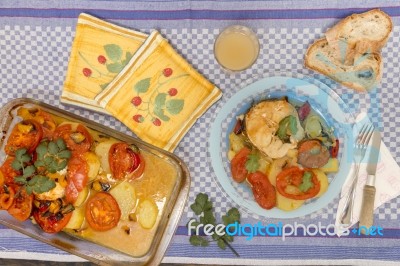 Fish With Potatoes And Tomato Stock Photo