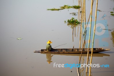 Fisherman Sitting On Boat Stock Photo