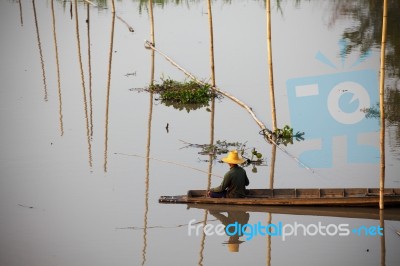 Fisherman Sitting On Boat Stock Photo