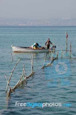 Fishermen Checking Their Nets At Lake Garda Stock Photo