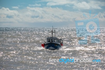 Fishing Boat Racing Home To Lyme Regis Harbour Stock Photo