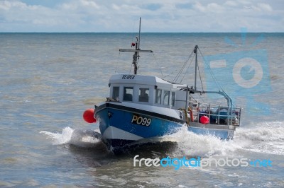 Fishing Boat Racing Home To Lyme Regis Harbour Stock Photo