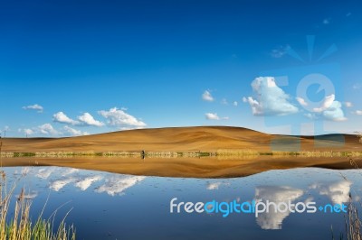 Fishing On A Calm Water. Hills And Sky Stock Photo