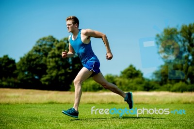 Fit Athlete Running Hard On A Sunny Day Stock Photo