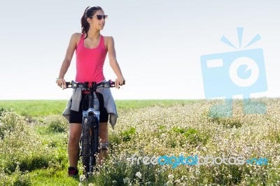 Fit Woman Riding Mountain Bike Stock Photo