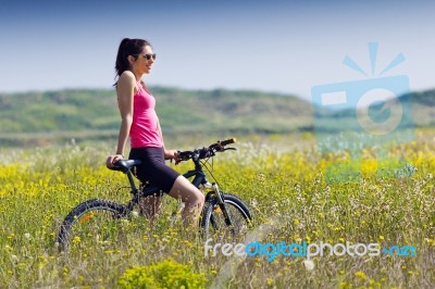 Fit Woman Riding Mountain Bike Stock Photo