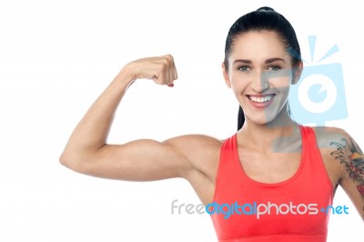 Fitness Trainer Flexing Her Biceps Stock Photo